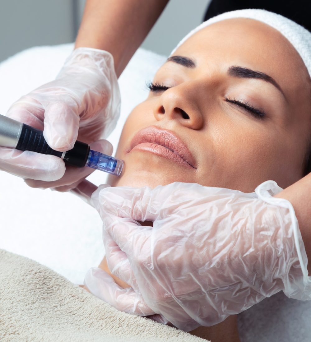 Cosmetologist making mesotherapy injection with dermapen on face for rejuvenation on the spa center.